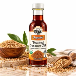 De La Rosa 613 organic toasted sesame oil with toasted sesame seeds on a marble surface