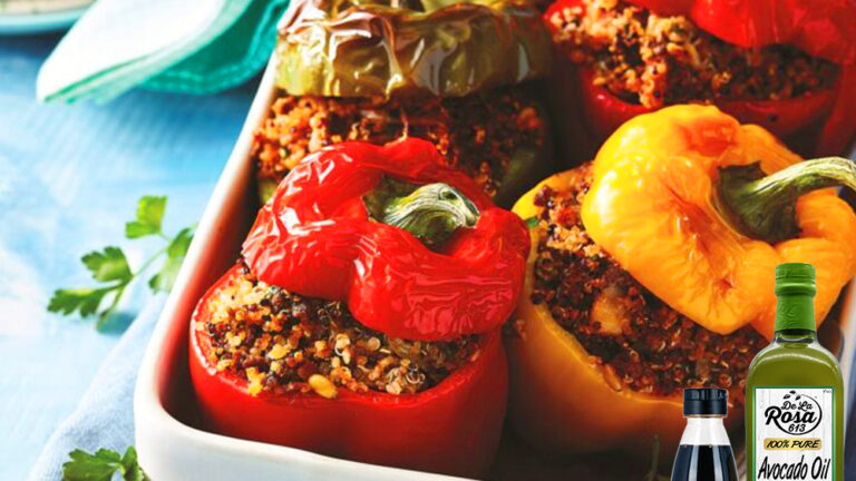 Balsamic-glazed lamb stuffed peppers with quinoa and vegetables, garnished with fresh mint and pomegranate arils.