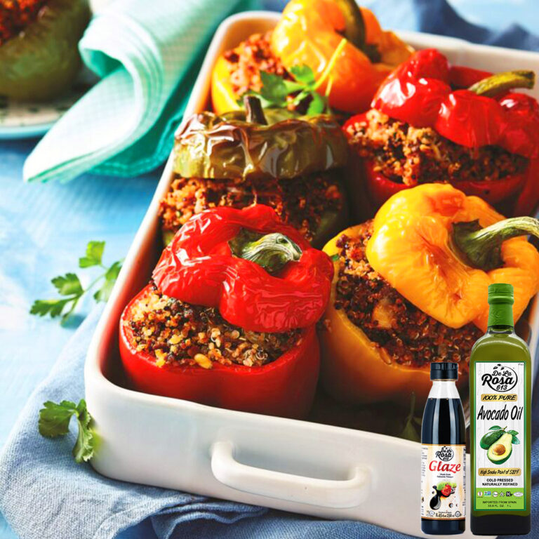 Balsamic-glazed lamb stuffed peppers with quinoa and vegetables, garnished with fresh mint and pomegranate arils.